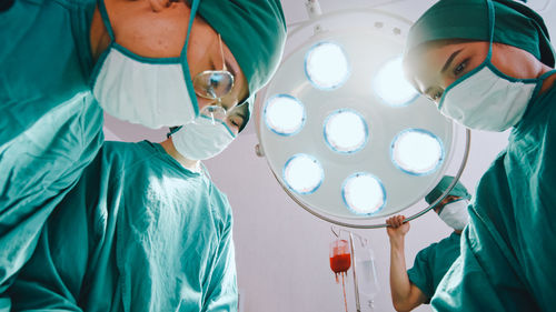 Low section of surgeons working in operating room