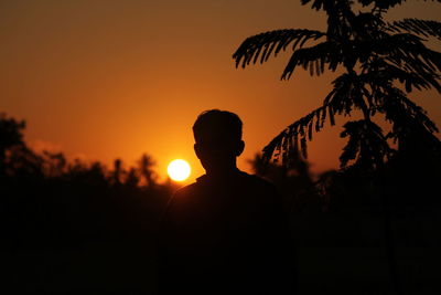 Silhouette man against sky during sunset