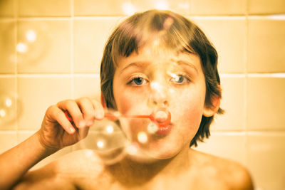 Close-up portrait of baby girl in bathroom