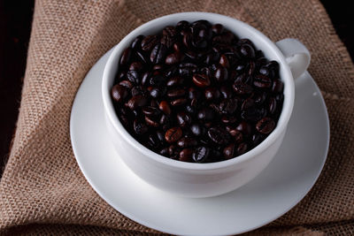 High angle view of coffee beans in bowl on table