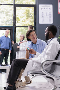 Female doctor examining patient in office