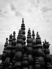 Low angle view of stack of chess against the sky