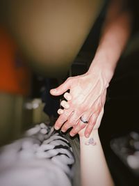 Midsection of couple holding hands