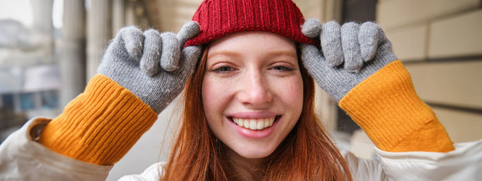 Portrait of young woman wearing hat