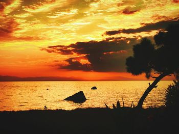 Scenic view of sea against romantic sky at sunset