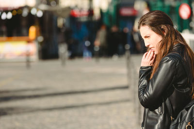 Woman looking at city street