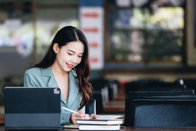 Businesswoman using laptop at office