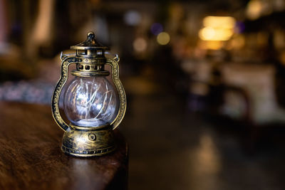 Old vintage rusty kerosene black lamp isoleted on gray background. glass oil lamp.