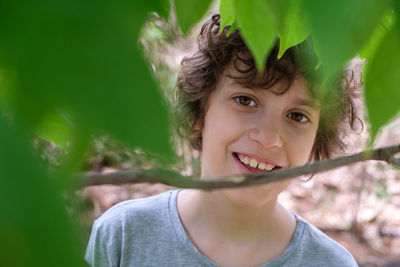 Close-up of portrait boy against leaves