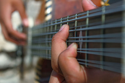 Midsection of person playing guitar