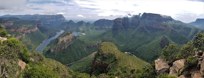 Panoramic shot of trees and mountains against sky