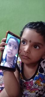 Portrait of smiling girl holding home