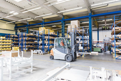 Man on forklift in factory warehouse