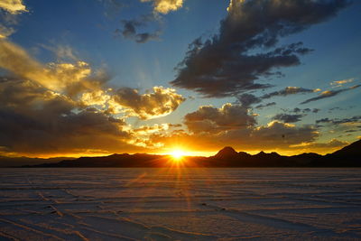 Scenic view of beach against sky during sunset