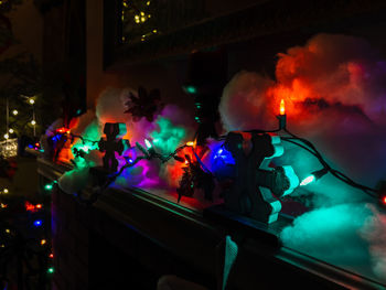 Diminishing perspective of fireplace mantle with christmas lights and holiday decorations