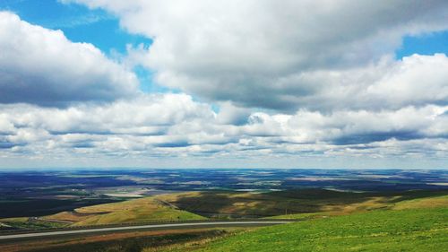 Scenic view of landscape against cloudy sky