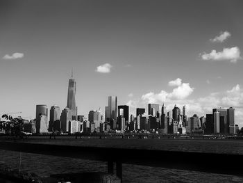 View of cityscape against cloudy sky