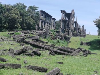 Old ruins on field against sky