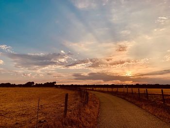 Scenic view of field against sky during sunset