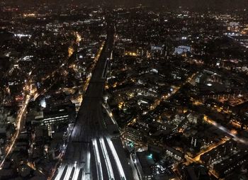 High angle view of city lit up at night