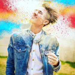 Young man smiling while standing outdoors