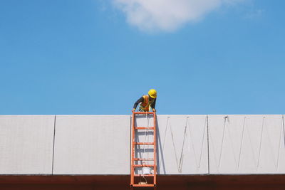 People working against blue sky