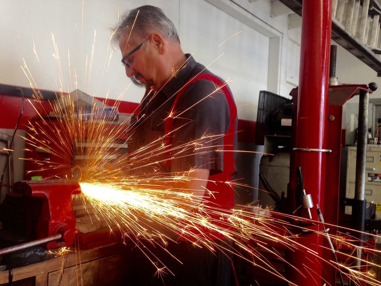 MAN WORKING AT ILLUMINATED FACTORY