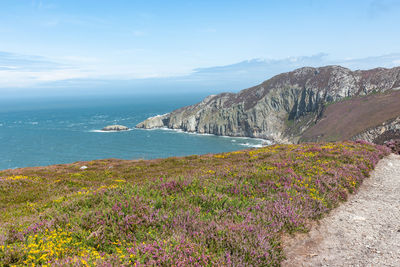 Scenic view of sea and mountains against sky