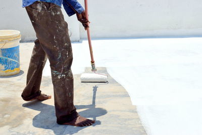 Painter painting roof of a house