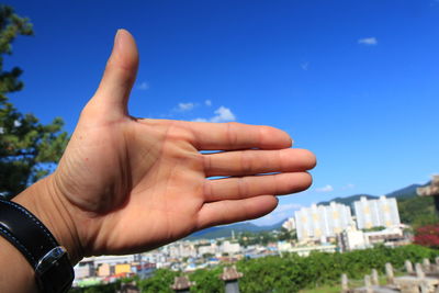 Midsection of person against blue sky