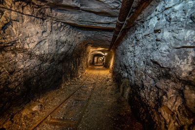 Narrow alley amidst old buildings in tunnel