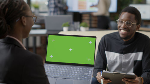 Young man using laptop at office