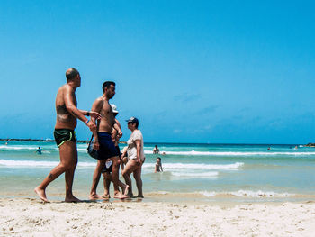 Full length of men on beach