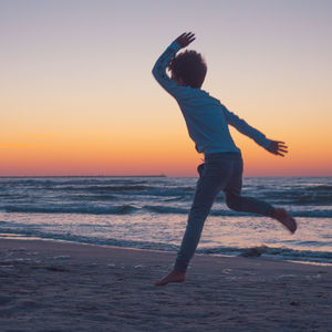 Full length of man at beach during sunset