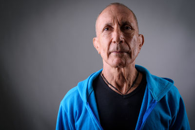 Portrait of man against blue background