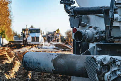 Close-up view of pipe of heavy equipment in the quarry.  heavy industrial machinery, trucks.