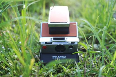 Close-up of camera phone on field