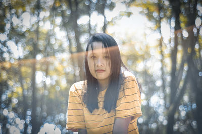 Portrait of young woman standing outdoors