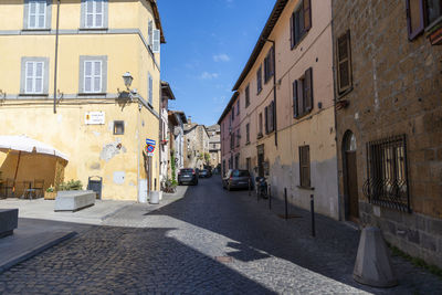 Cars on street amidst buildings in city