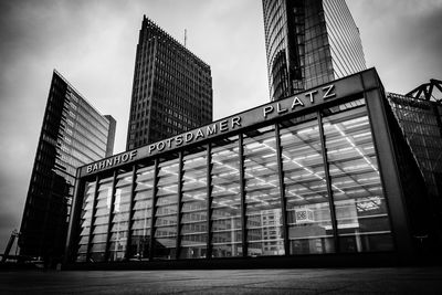 Low angle view of modern building against cloudy sky