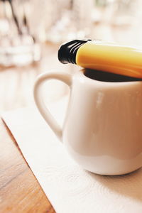 Close-up of coffee and cigarette lighter on table