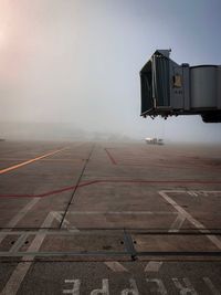 Airport runway against sky during fogy weather