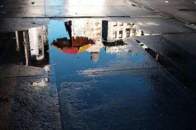 Reflection of building in puddle