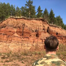 Rear view of boy on rock