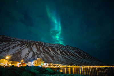 Scenic view of illuminated mountain against sky at night