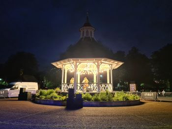 Illuminated building against sky at night