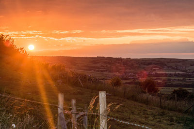 Scenic view of field against sky during sunset