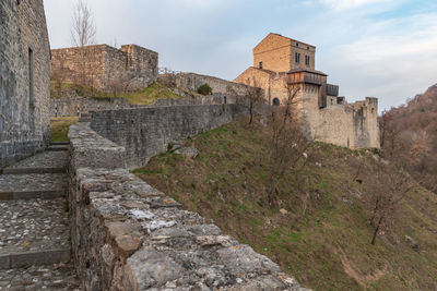 Sunset on the ancient castle of ragogna, italy. fortress guarding the ford on the river tagliamento