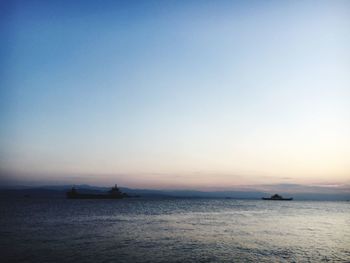 Scenic view of sea against clear sky during sunset