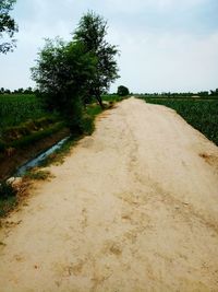 Empty road along countryside landscape